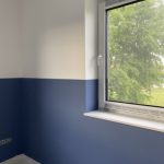 Blau-weiß bemalte Wand am Fenster